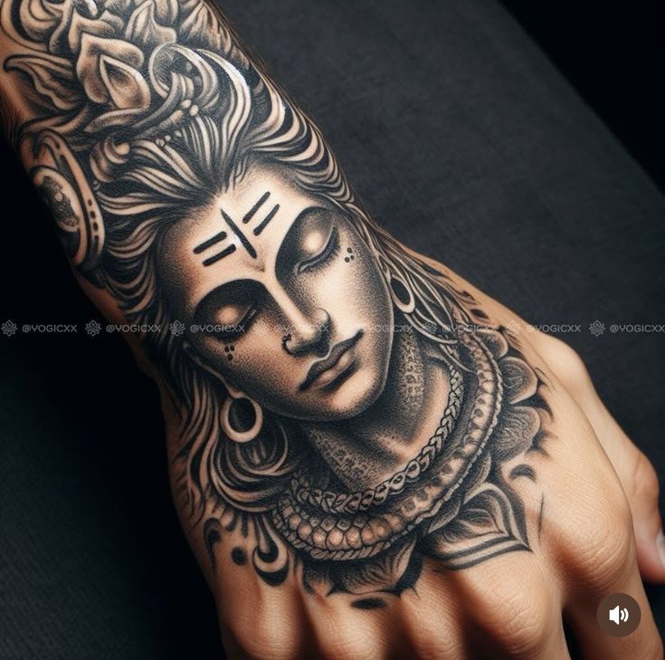 a person's hand with a tattoo on it and an image of a buddha