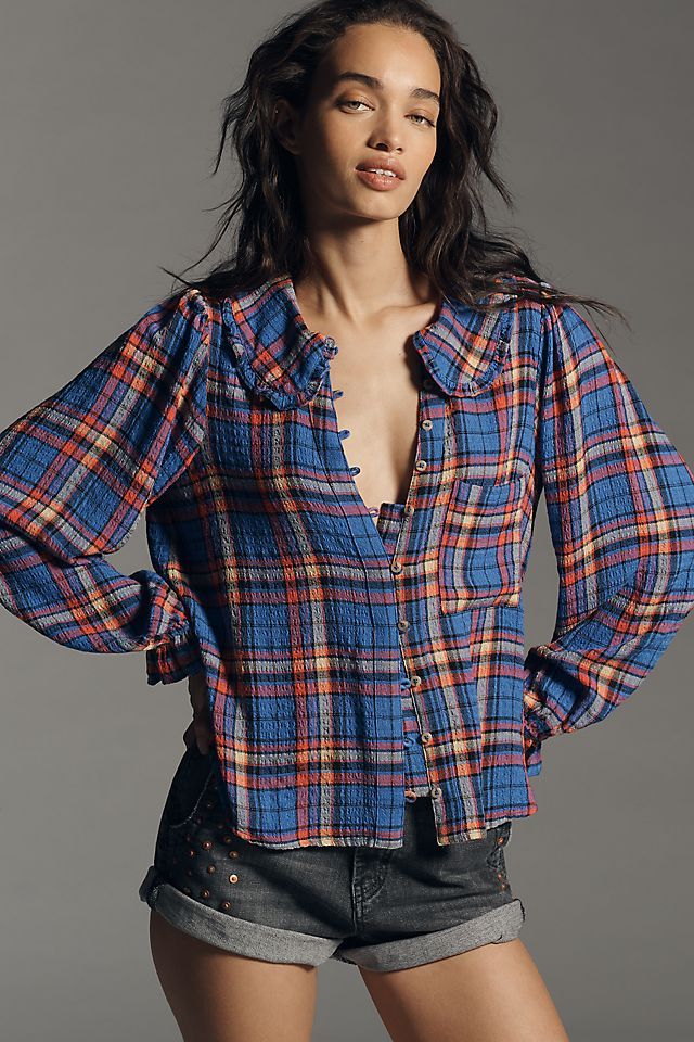 a woman in short shorts and a plaid shirt