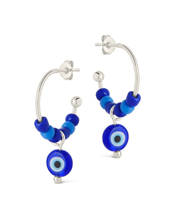 Add a touch of coastal charm to your wardrobe with these Sibyl Evil Eye Beaded Hoop Earrings. Featuring the ancient symbol of protection, these blue beaded hoops will add a hint of beachy elegance to any outfit. Embrace the luxurious and exclusive look of these earrings, perfect for any occasion. Material: 14K gold or rhodium plated brass, colored glass beads Features: 0.75" hoop, 0.6" charm, 3.75mm beads, 7.65mm evil eye bead, Lead & Nickel free, post back Blue Beaded Small Hoop Earrings, Blue Beaded Small Hoop Jewelry, Small Blue Beaded Hoop Earrings, Blue Small Hoop Beaded Earrings With Dangling Beads, Adjustable Small Blue Hoop Earrings, Adjustable Small Hoop Earrings In Blue, Blue Small Hoop Earrings For Summer, Blue Small Hoop Beaded Earrings For Summer, Blue Small Hoop Jewelry With Dangling Beads