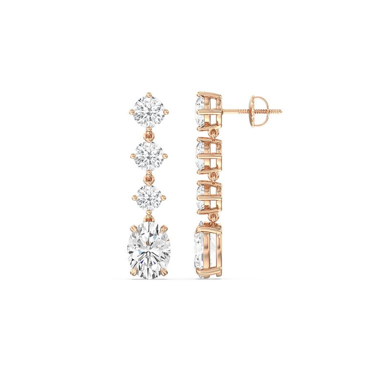 These diamond danglers exude a sense of sophistication and ease. They look relaxed and refined at once with their linear design and subtle movement. Each earring features a trio of round diamonds set in a vertical row and punctuated by a larger oval-cut diamond at the end. This elegant pair is the perfect choice when you want to dress to impress yet still be comfortable. Modern Round Linear Earrings For Formal Occasions, Modern Linear Round Earrings For Formal Occasions, Modern Cubic Zirconia Linear Earrings For Formal Occasions, Timeless Linear Earrings With Diamond Accents, Modern Linear Earrings With Diamond Accents For Formal Events, Modern Linear Earrings With Diamond Accents For Formal Occasions, Timeless Round Linear Earrings For Formal Occasions, Timeless Round Linear Earrings For Formal Events, Classic Diamond White Linear Earrings