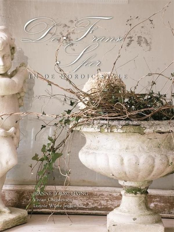 a bird nest sitting on top of a white vase