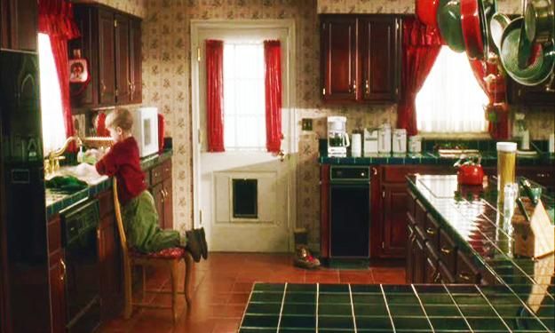 a woman is sitting at the kitchen counter