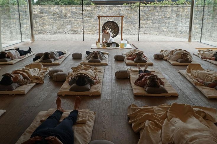 a group of people laying on mats in a room