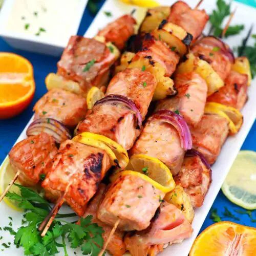 chicken kabobs on skewers with lemons and parsley