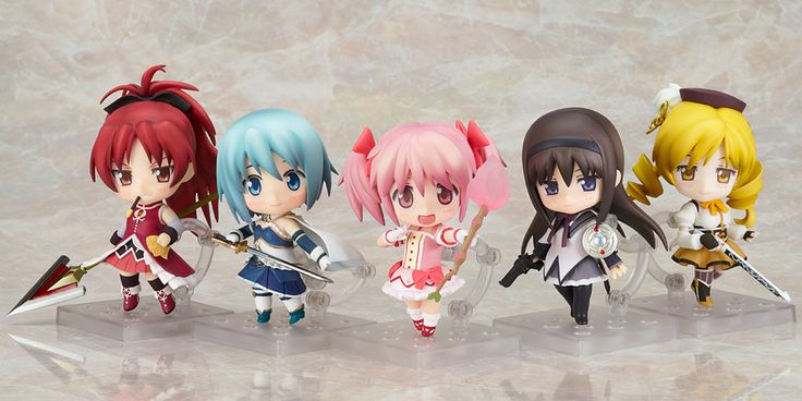 four anime figurines sitting on top of a table