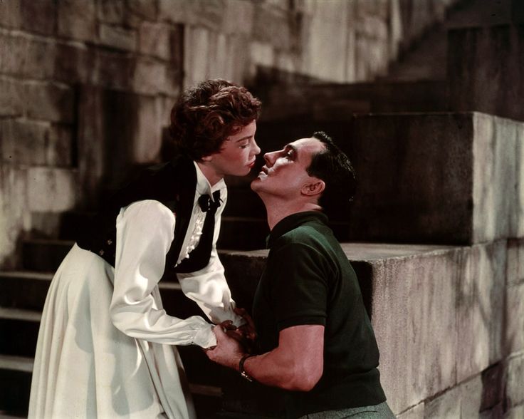 a man and woman kissing each other on the steps