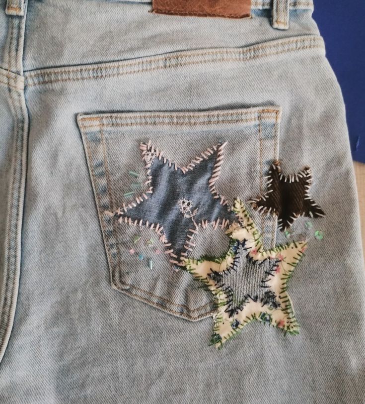 a pair of jeans with embroidered stars on them