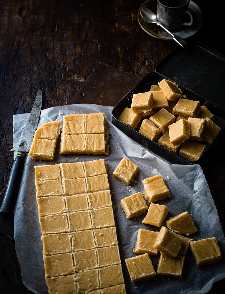 pieces of tofu sitting on top of a pan next to a knife and fork