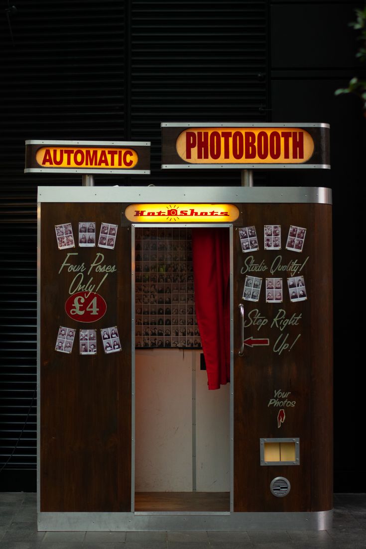 an automated photo booth is lit up at night