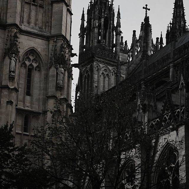 an old gothic church with steeples and clocks