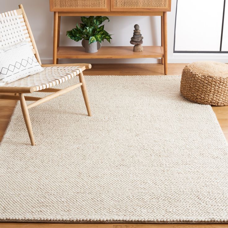 a living room with a chair and rug on the floor