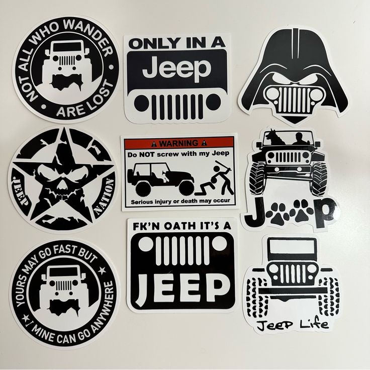 various stickers are displayed on a white surface, including jeeps and star wars logos