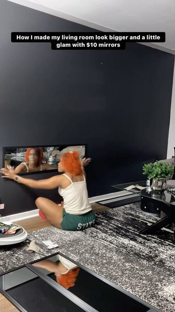 a woman sitting on the floor in front of a tv with her legs spread out