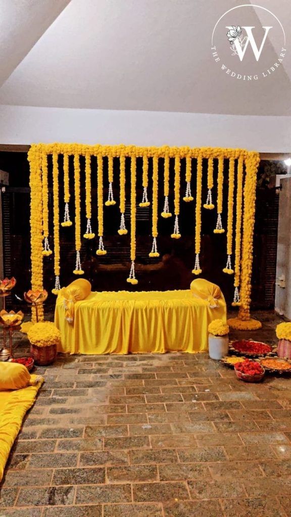 Simple Haldi Stage Decoration At Home, Haldi Decoration Ideas Simple, Haldi Decoration Ideas At Home For Groom, Haldi Decorations At Home, Holud Decoration At Home, Home Haldi Decor, Haldi Backdrop Stage Decorations, Haldi Ceremony Decorations Indoor, Simple Haldi Decoration At Home