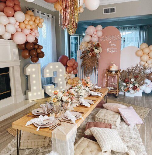 a table set up with balloons and decorations