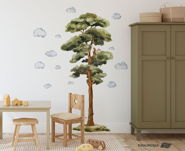 a child's room with a tree and clouds painted on the wall