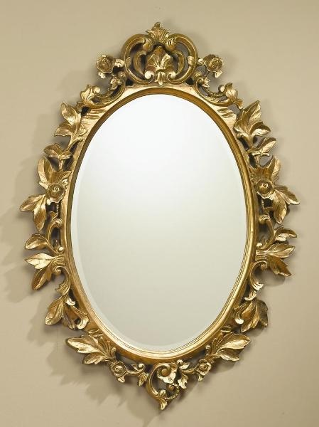 an ornate gold mirror hanging on the wall