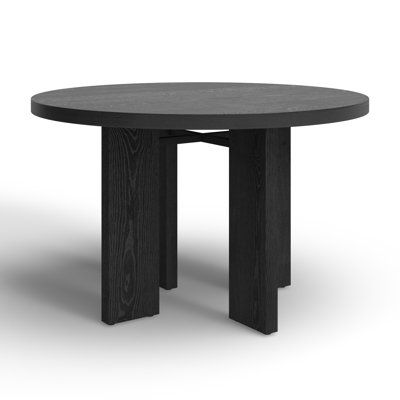 a round table with black wood legs on an isolated white background