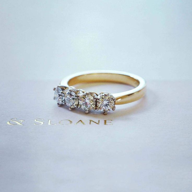 three stone diamond ring in yellow gold