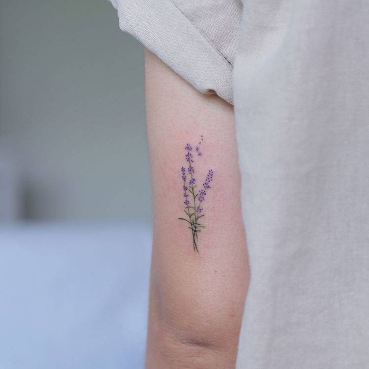 a small lavender tattoo on the left arm