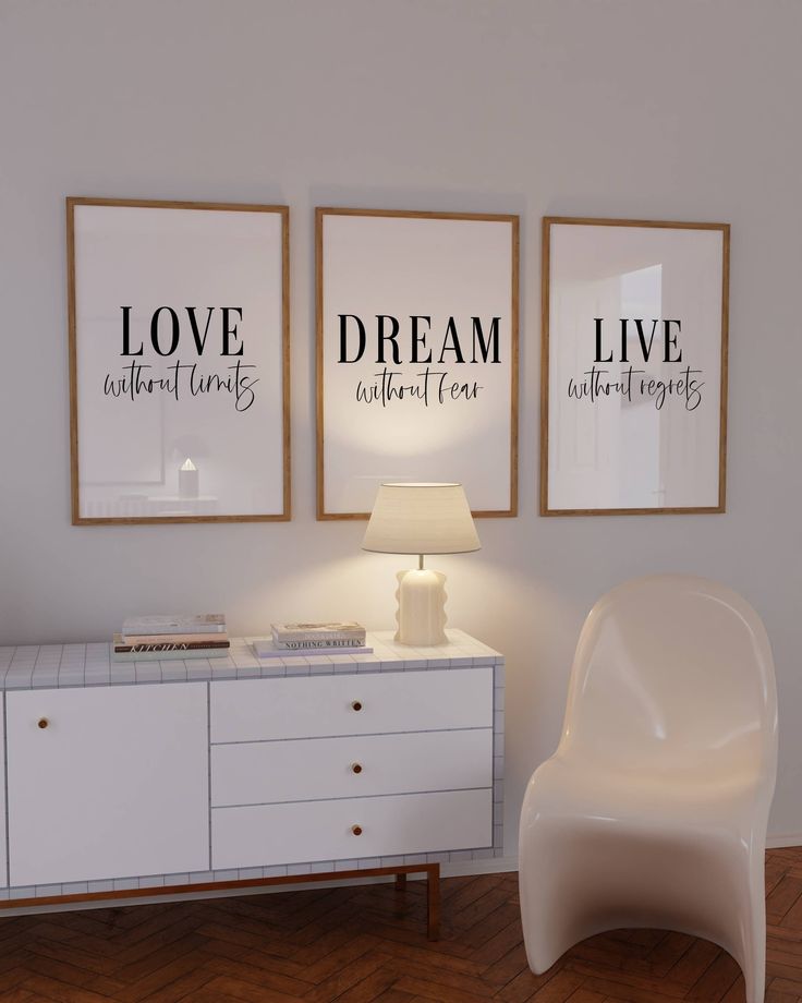 two posters on the wall above a white dresser