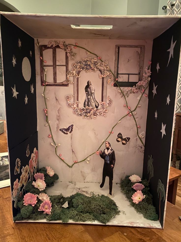 a cardboard box with an image of a man standing in front of flowers and butterflies