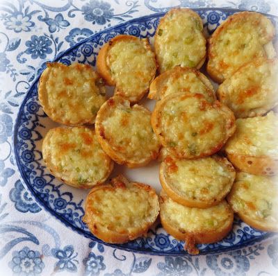 a blue and white plate filled with mini muffins on top of a table