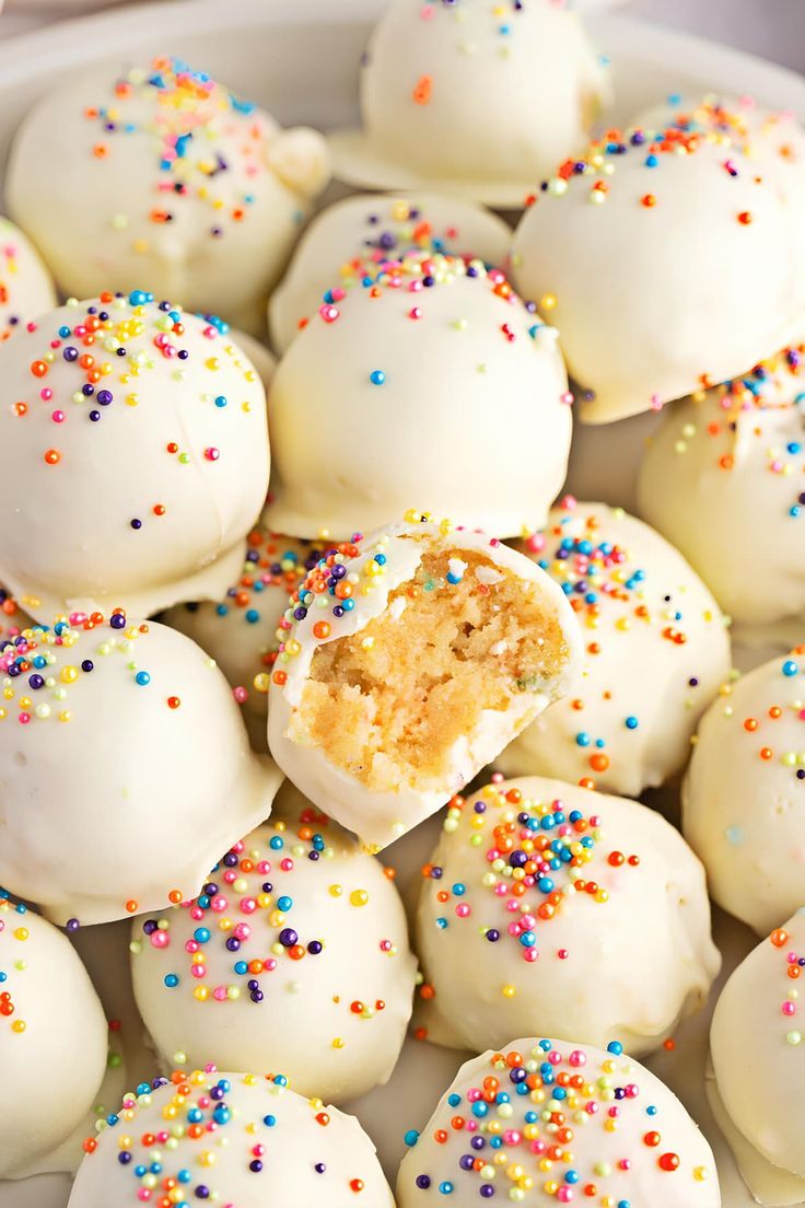 white chocolate covered donuts with colorful sprinkles