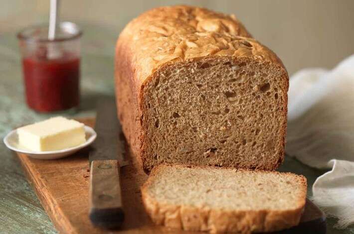 a loaf of bread sitting on top of a wooden cutting board