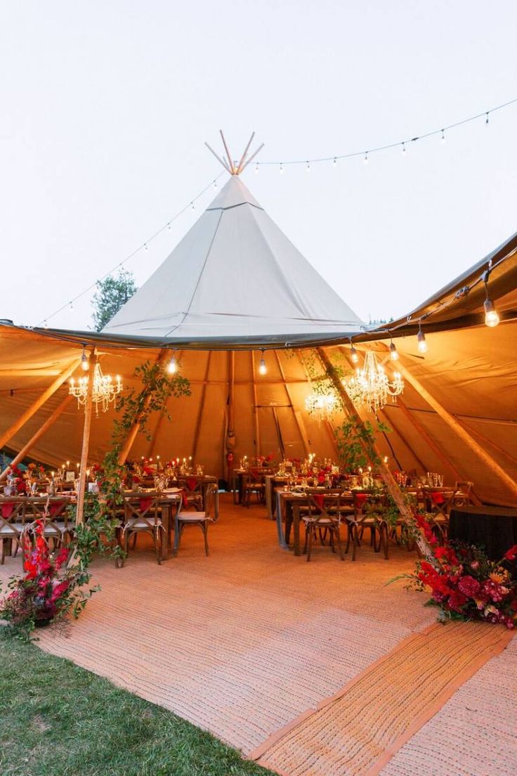 a large tent set up with tables and chairs