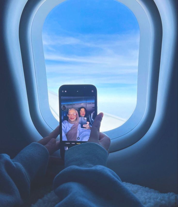 someone is taking a photo of themselves on their cell phone while flying in the sky