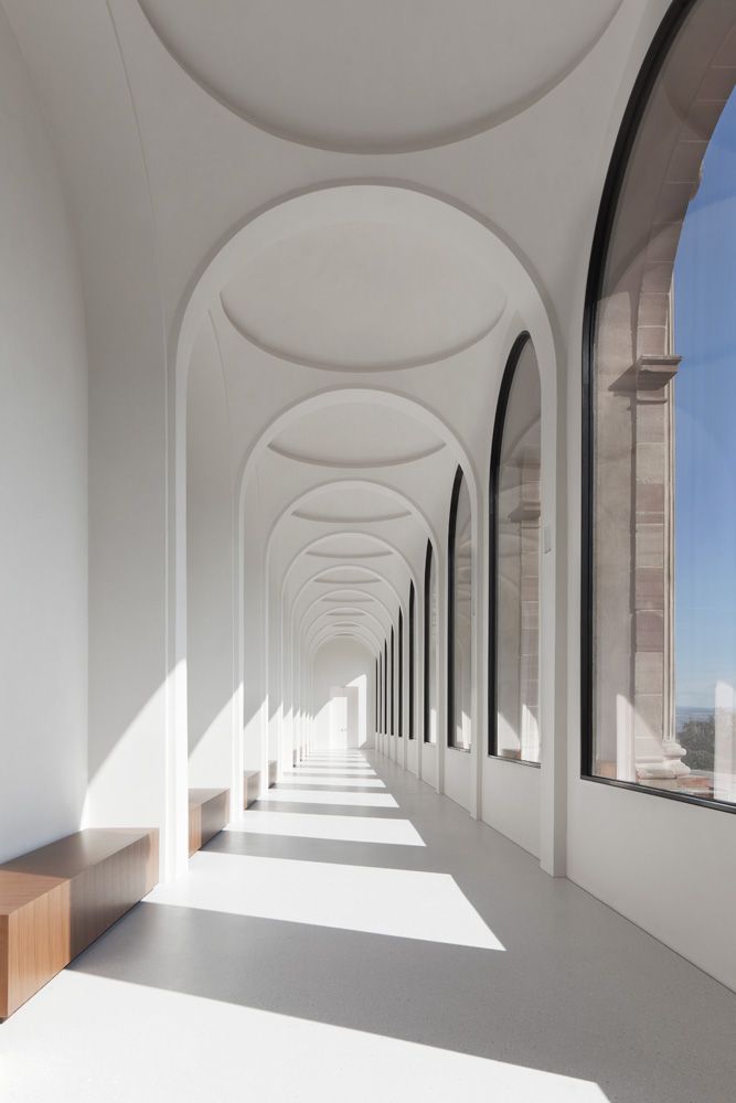 an instagram photo with white walls and arched windows