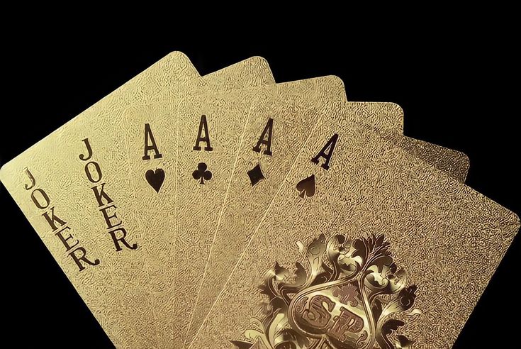 four gold playing cards with black background