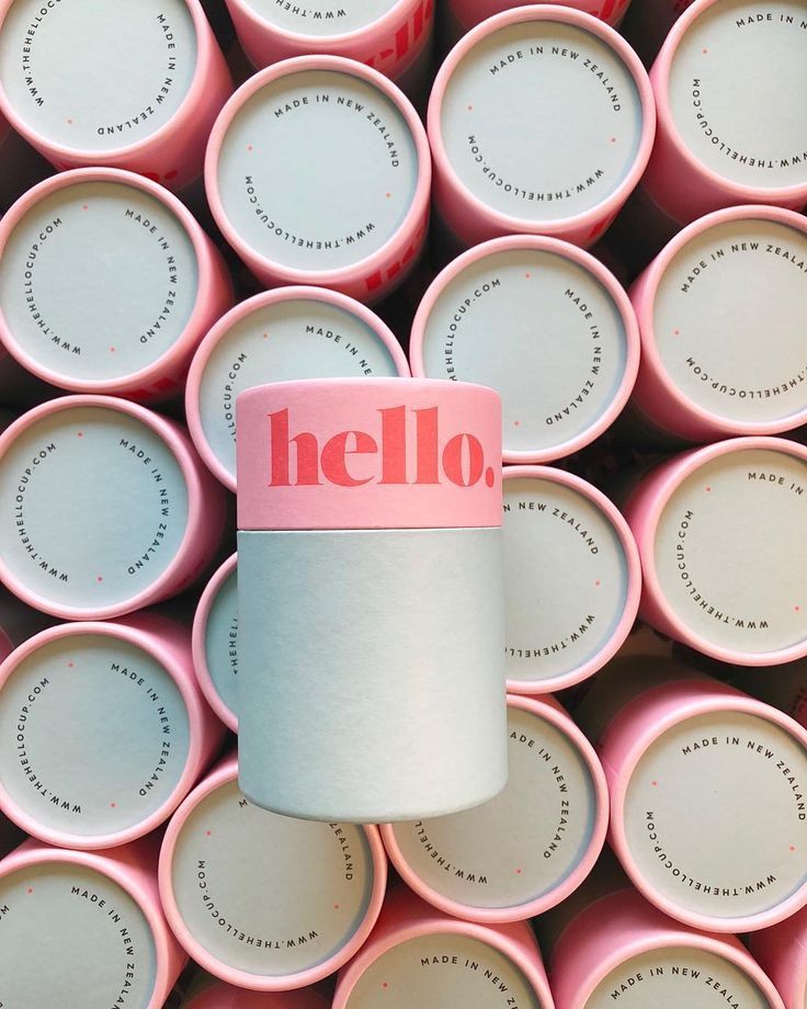 a stack of pink cups with the word hello printed on them and a roll of toilet paper