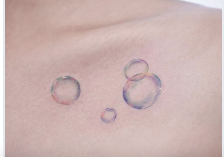 two water droplets on the back of a man's chest