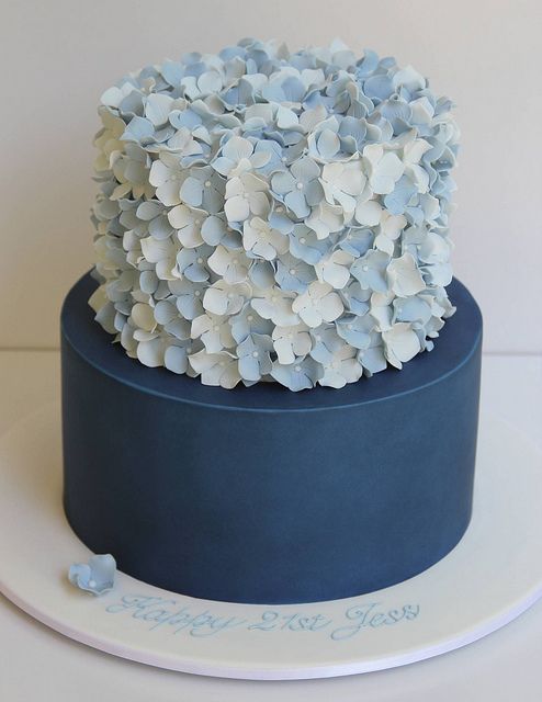 a blue and white cake with flowers on the top is for 2 - tier hydrangea cake by creative cakes