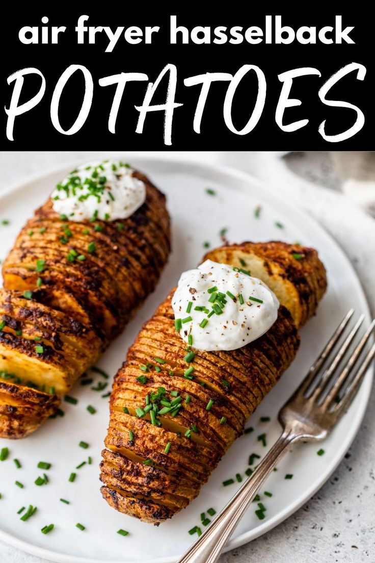 two grilled potatoes on a white plate with whipped cream and chives in the middle