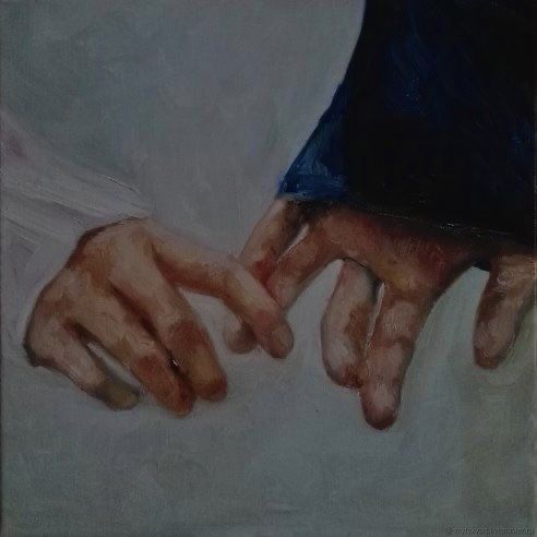 two hands touching each other on a white surface