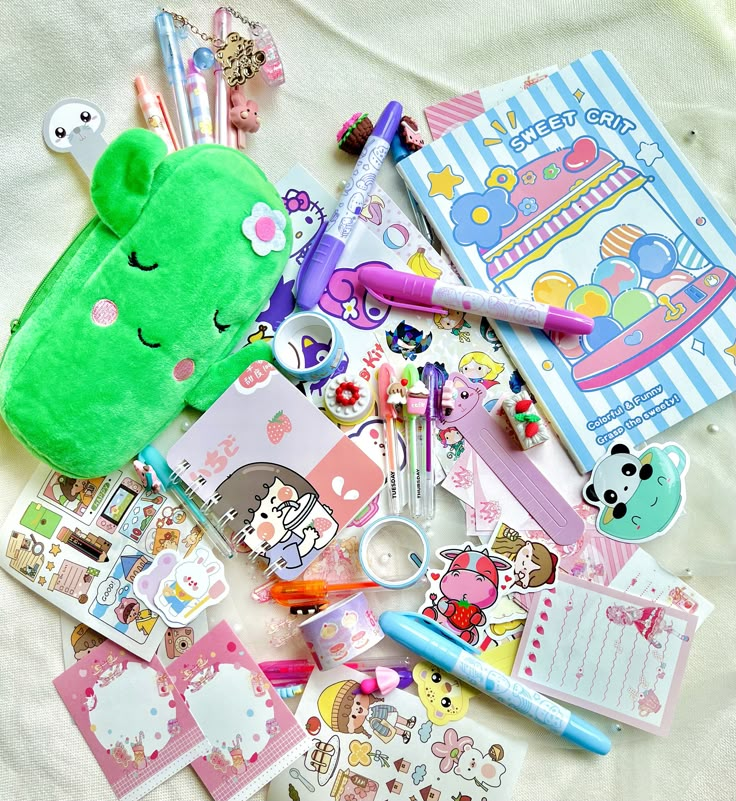 a pile of stationary items on top of a bed