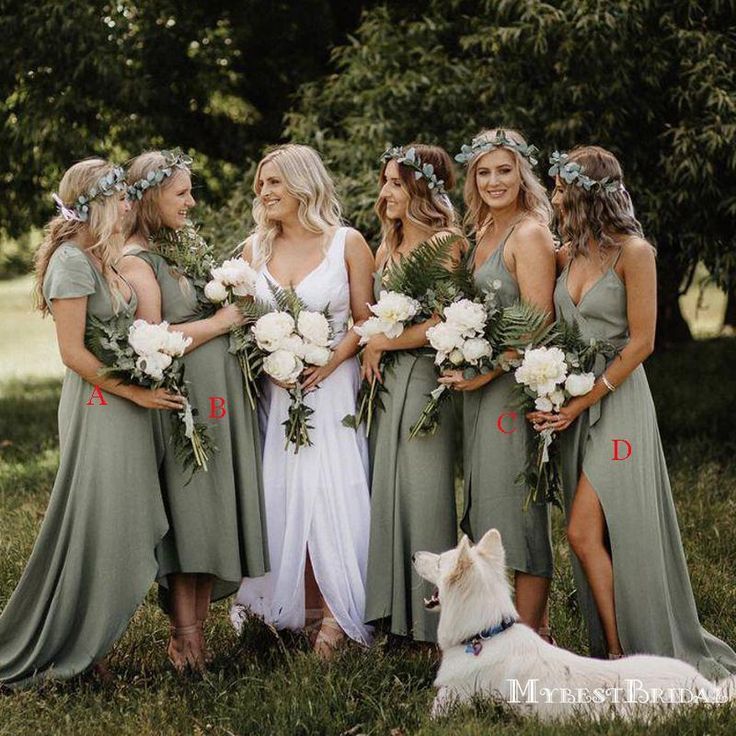 a group of women standing next to each other on top of a lush green field