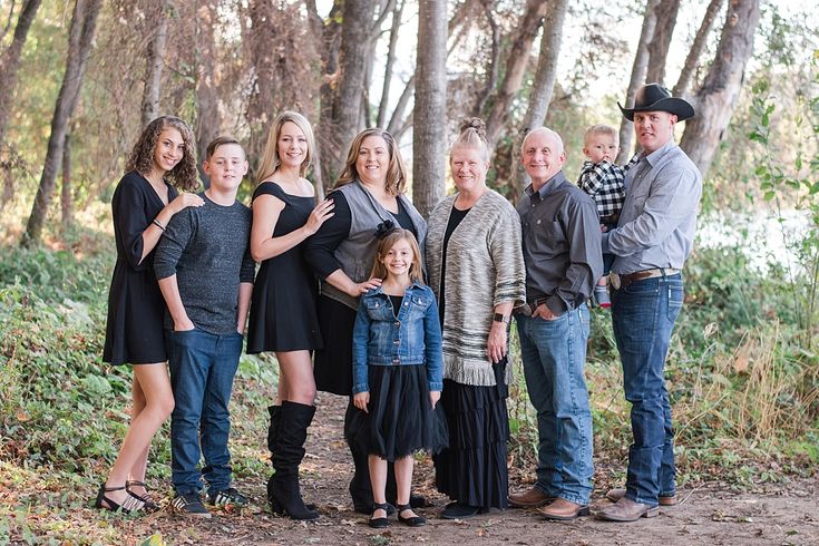 a family posing for a photo in the woods