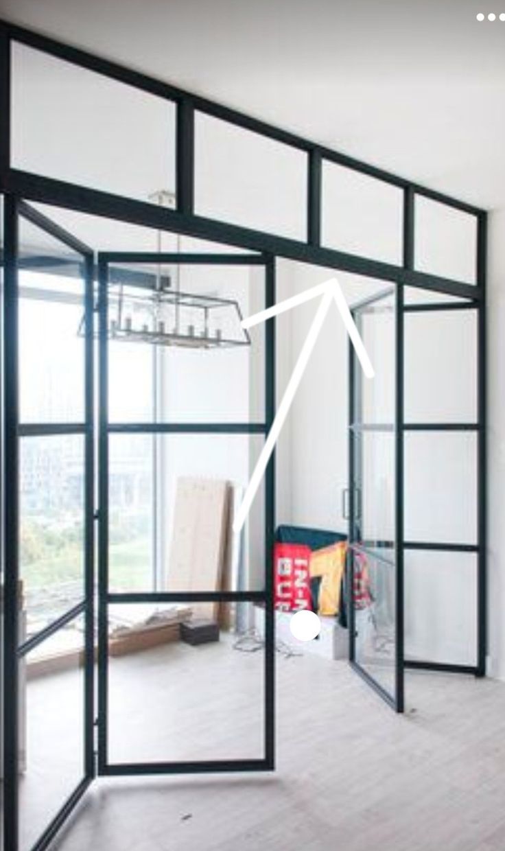 an empty room with glass doors and white walls