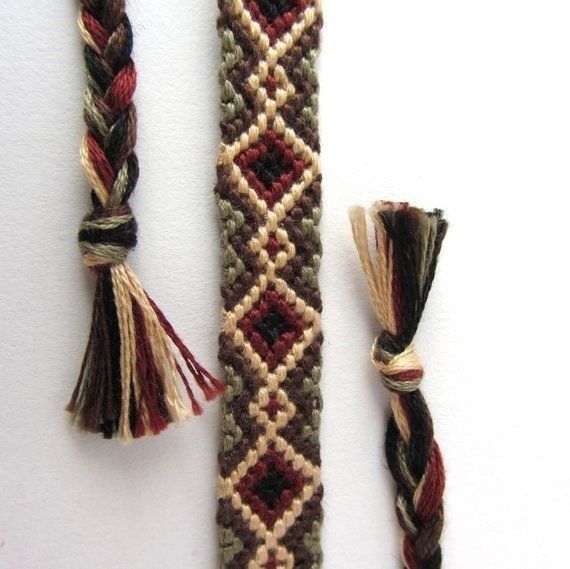 two pieces of woven material with tassels on top of each other next to one another