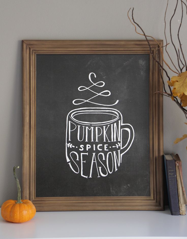 a chalkboard sign that says pumpkin spice season