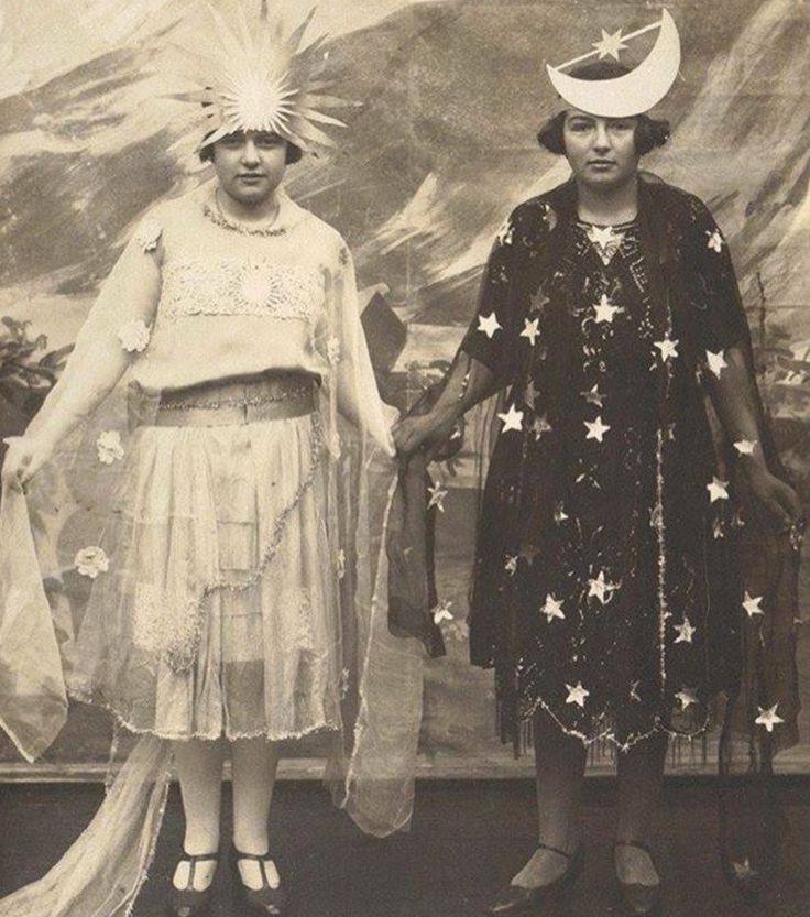 two women standing next to each other in front of a wall with stars on it