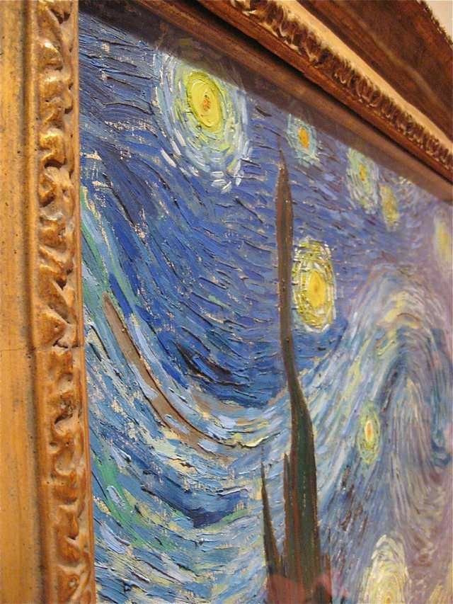 the painting is hanging on the wall in front of the window and it looks like starry night