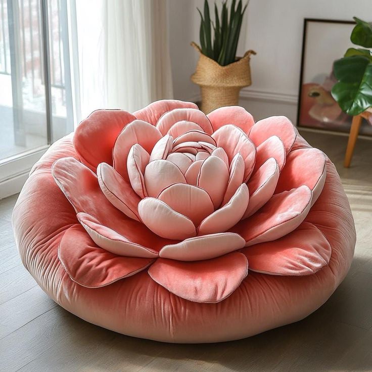 a large pink flower sitting on top of a floor