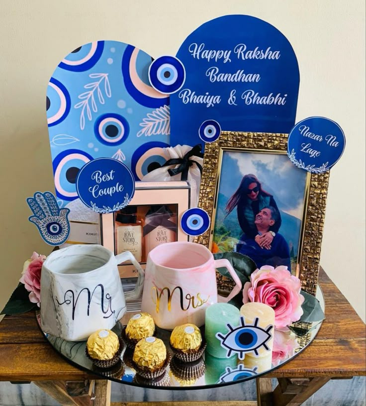 a table topped with pictures and cupcakes on top of a wooden table next to a framed photo