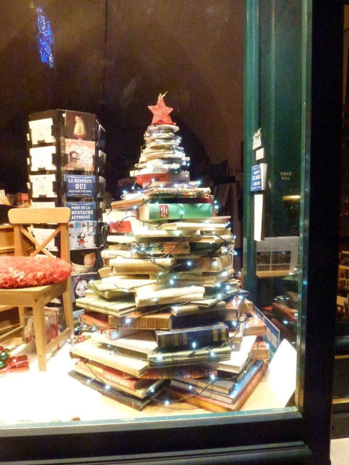 a christmas tree made out of books in a store window