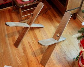 two wooden planes sitting on top of a hard wood floor next to a christmas tree